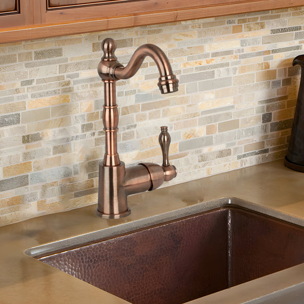 Antique copper widespread kitchen bar faucet with a high curved spout and a separate side lever for control.