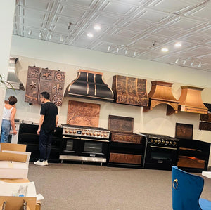 Showroom with kitchen appliances and decorative wall art