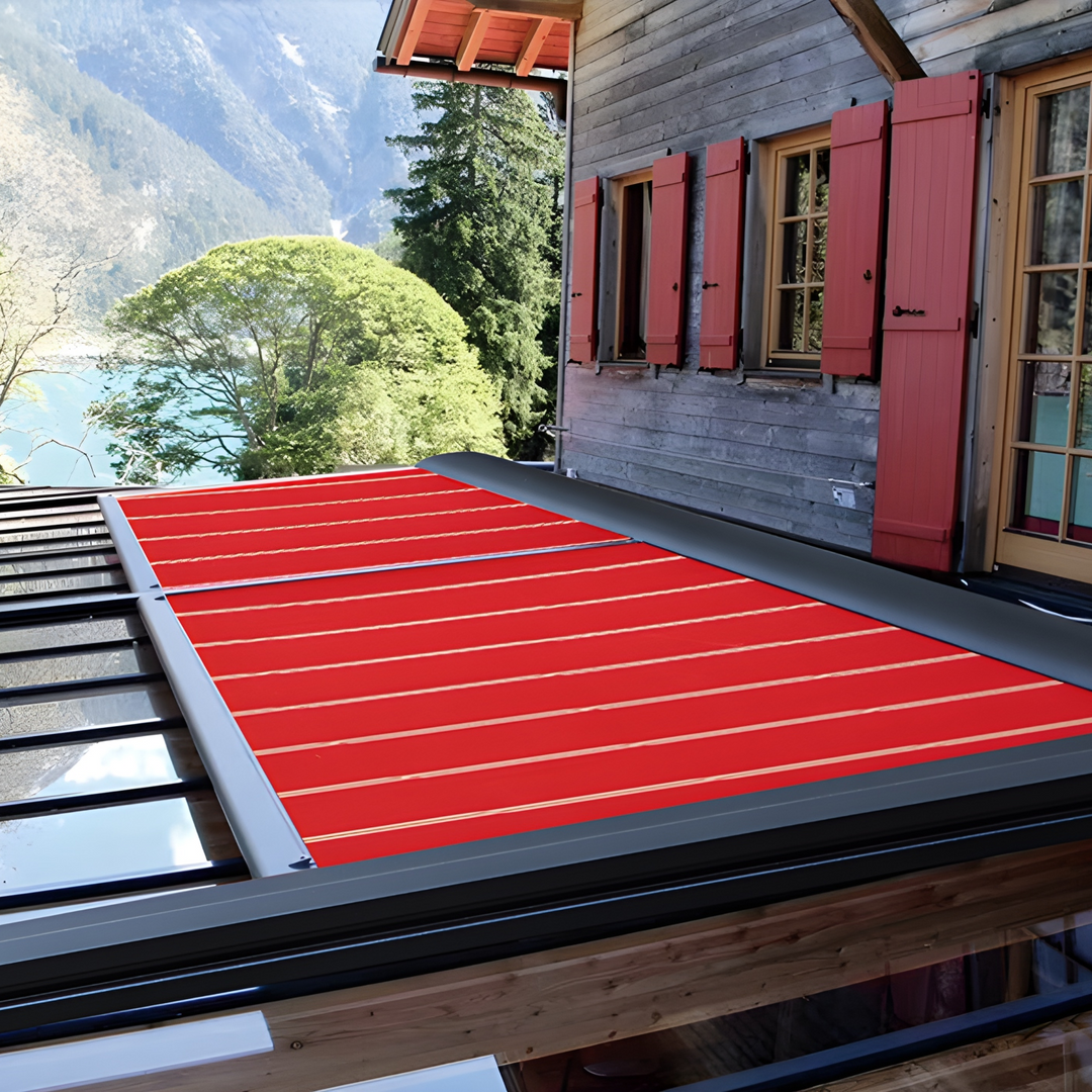 Red retractable roof on a wooden cabin with mountain and lake view