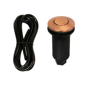 An image showing a copper garbage disposal air switch with an attached air hose against a white background.