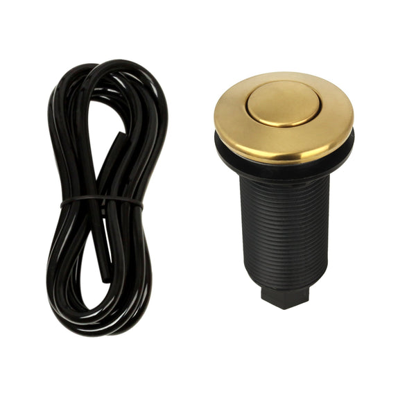 A brushed gold garbage disposal air switch with a brass button and an attached black air hose.