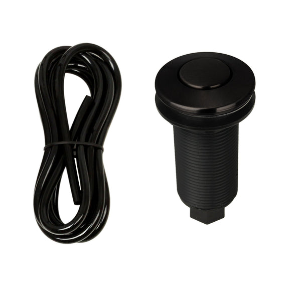 A matte black garbage disposal air switch with a brass button and an included air hose.