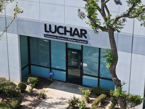 Building exterior with 'Luchar' branding and outdoor kitchen cabinet customization service.
