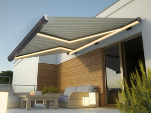 Outdoor patio with a retractable awning, table, and sofa under a clear sky.